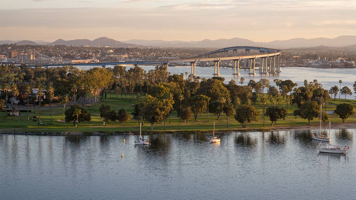 Aerial view looking over Coronado Island and the bridge that leads to the mainland at dusk near San Diego, California, USA